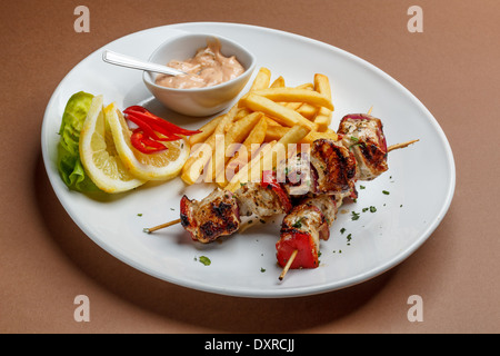 Gegrilltes Fleisch mit Pommes Frites und Soße Stockfoto