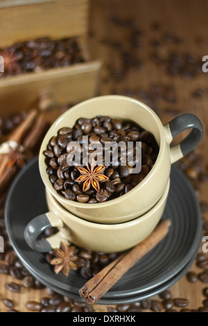 Geröstete Kaffeebohnen mit Sternanis und Zimt in die Keramik Kaffeebecher / selektiven Fokus. Stockfoto