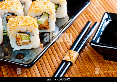 Japanische Rollen auf einem schönen schwarzen Geschirr Stockfoto