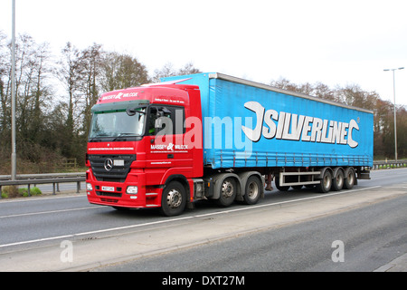 Massey und Wilcox Sattelzugmaschine schleppen Silverline Anhänger entlang der A12 Schnellstraße in Essex, England Stockfoto