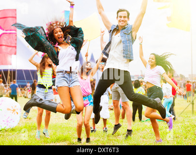 Porträt von begeisterte Freunde springen und tanzen beim Musikfestival Stockfoto