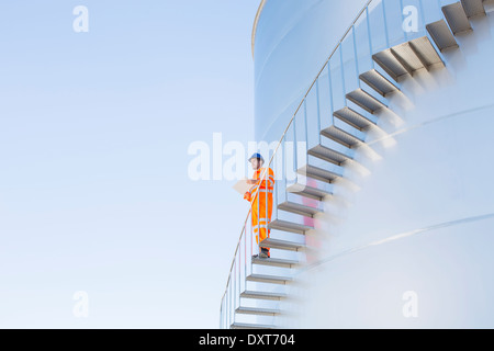 Arbeiter mit Papierkram auf Treppen entlang Silage Lagerung Turm Stockfoto