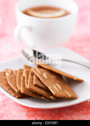 Zimt und dünn geschnittenen Mandelgebäck, eine Tasse Kaffee Stockfoto