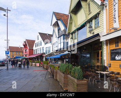 Draußen locken Restaurants in alten Lagerhäusern, Cafés und Bars immer wenn die Sonne bei einem Auftritt, Stavanger Norwegen setzt Stockfoto