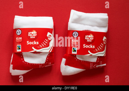 zwei Paare von roten und weißen Sport Relief 2014 Socken isoliert auf rotem Grund Stockfoto