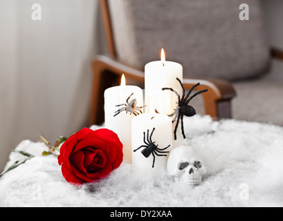 Graue Polsterstuhl in Halloween Ambiente mit Kerzen Stockfoto