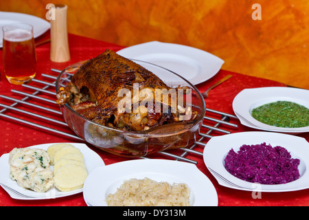 gebratene Gans auf einer Platte auf einem gedeckten Tisch Stockfoto