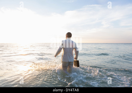 Unternehmer stehen im Meer, Rückansicht Stockfoto