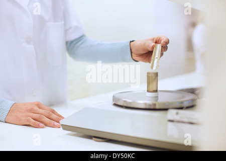 Apothekerin mit einem Gewicht von Medizin für verschreibungspflichtige Stockfoto