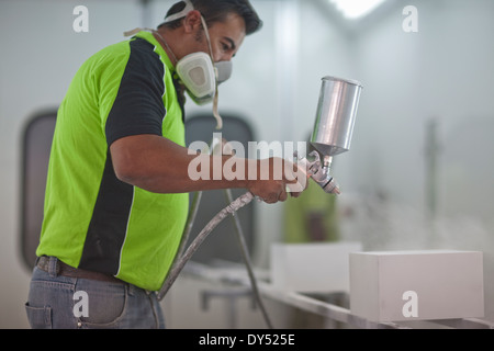 Mann Spritzen Holzprodukte in Tischler Werkstatt Stockfoto