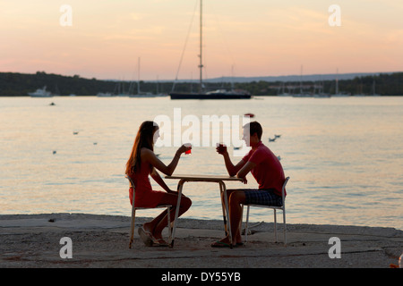 Junges Paar, toasten einander am Pier, Loviste, Kroatien Stockfoto