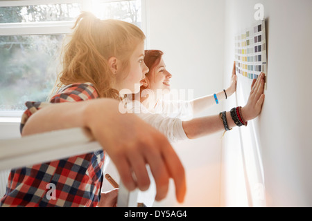 Teenager Schwestern halten Farbfeld an Wand Stockfoto