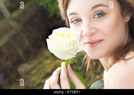 Porträt der jungen Frau hält eine rose Stockfoto