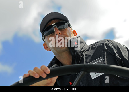 Skipper trägt Sonnenbrille am Steuer eines Ozeans Rennyacht Konzentration Stockfoto