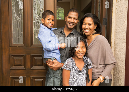Porträt von Mitte Erwachsenen Eltern mit Sohn und Tochter an der Haustür Stockfoto