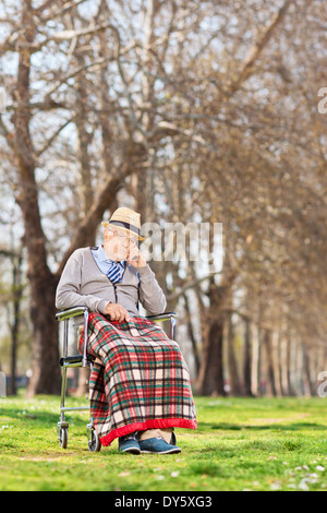 Verärgert, senior sitzt in einem Rollstuhl im freien Stockfoto