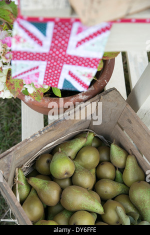 Schachtel mit Konferenz-Birnen mit shabby chic Union Jack Flagge Wimpel in den Hintergrund-Dekorationen für Hochzeiten Obstgarten Stockfoto