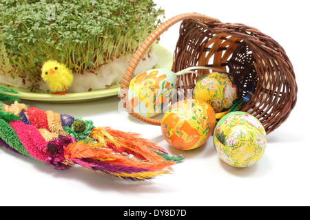 Bunte Ostern Palm, bemalte Ostereier in umgestürzten Weidenkorb und frische grüne Kresse, Brunnenkresse, Oster-Deko Stockfoto