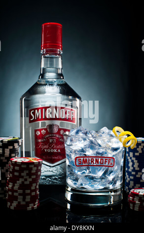 Smirnoff Vodka Flasche und Glas auf einem Tisch mit Poker-chips Stockfoto