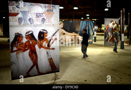 Oberhausen, Deutschland. 10. April 2014. Zwei Männer Fuß durch die Ausstellung "The Aussehen of Beauty" im Gasometer, einem ehemaligen Gasspeicher in Oberhausen, Deutschland, 10. April 2014. Im Vordergrund: das Bild der Wandmalerei "Drei Musiker mit Doppel-Querflöte, laute und Harfe" von einem unbekannten Künstler. Die Ausstellung "The Aussehen of Beauty" läuft vom 11. April bis 30. Dezember 2014 und zeigt mehr als 150 Fotografien oder Abgüsse von bedeutenden Kunstwerken aus verschiedenen Epochen. Foto: Matthias Balk/Dpa/Alamy Live News Stockfoto