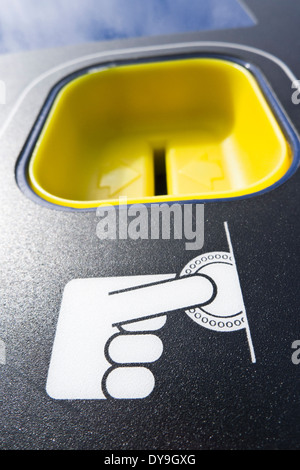 Münzeinwurf auf ein Parkautomat. Stockfoto