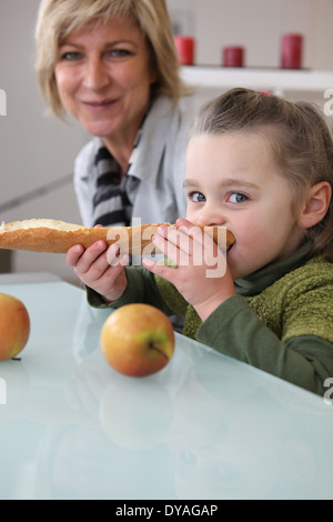 Kleine Mädchen essen Brot Stockfoto