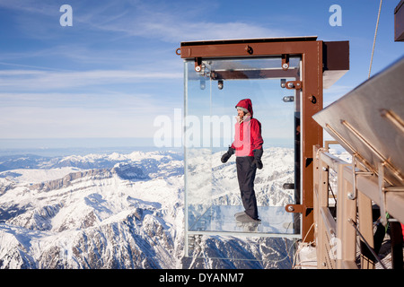 Ein Tourist steht im Feld "Schritt ins Leere" Glas auf die Aiguille Du Midi (3842m) Berggipfel über Chamonix Mont-Blanc Stockfoto