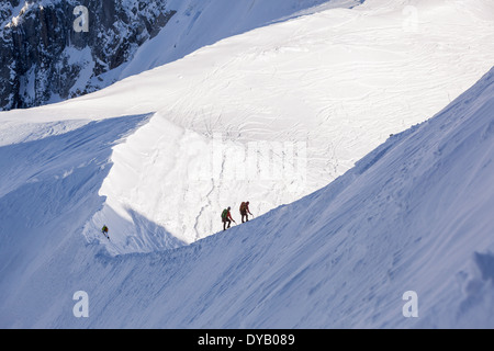 Bergsteiger und Skifahrer steigen von einem Aussichtspunkt auf die Aiguille Du Midi (3842m) Berggipfel über Chamonix Mont-Blanc. Stockfoto