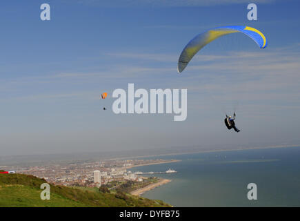 Beachy Head, Eastbourne, East Sussex, Großbritannien..16. April 2014..Gleitschirmflieger nutzen die steife Brise aus dem Süden über Eastbourne an der Sussex Coast. Stockfoto