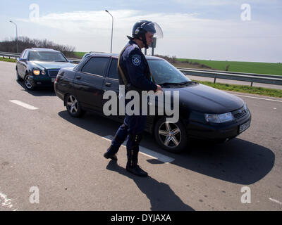 Lugansk, Ukraine. 19. April 2014. Polliceman auf Verordnung Verkehrsknotenpunkt---In Lugansk angespannt. Stadt umgeben Verkehrsregelung Punkt. Polizei, bewaffnete Kalaschnikow überprüfen Sie sorgfältig jeden PKW und LKW. Fahrer und Beifahrer werden zu diesem Verständnis behandelt. Bildnachweis: Igor Golovnov/Alamy Live-Nachrichten Stockfoto