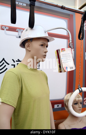 Männlichen Zug Passagier oder Dummy schwer Helm mit Buchstütze in Zug. Nutzlose japanische Gadget oder Chindogu. Stockfoto