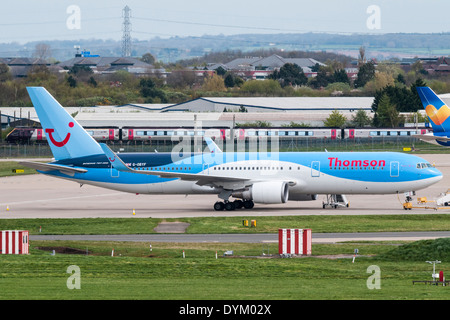 Thomson Airways Boeing 767-Flugzeuge in Birmingham International Airport mit einem länderübergreifende Personenzug im Hintergrund Stockfoto