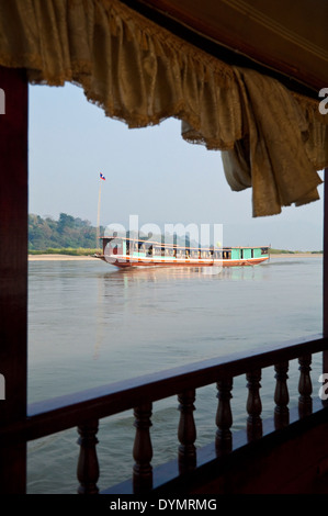 Vertikale Ansicht von einem laotischen langsamen Boot auf dem Mekong Fluss an einem sonnigen Tag. Stockfoto