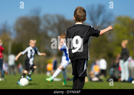 Drei kleine Jungen Fußball spielen, während der Sommerzeit. Marken sind entfernt worden. Stockfoto