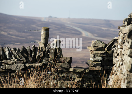 Stil über Trockenmauer am Rand der Axt im Peak District National Park mit der Katze und die Geige Pub auf der A537 in der Ferne Stockfoto