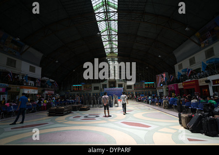 Thai Bahnhof einen großen Saal Innenraum bei Hua Lamphong in Bangkok, Thailand statt. Es sind Passagiere sitzen & stehen verstreut. Stockfoto