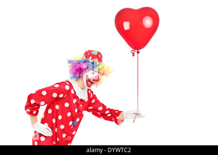 Männlichen Clown hält einen roten Ballon Stockfoto