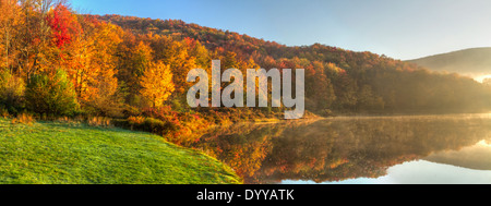 Sonnenlicht Abbrennen der Morgennebel auf Erle See an einem bunten Herbsttag in den Catskills Mountains von New York Stockfoto