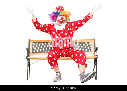 Clown gestikulieren Glück auf Bank sitzend Stockfoto