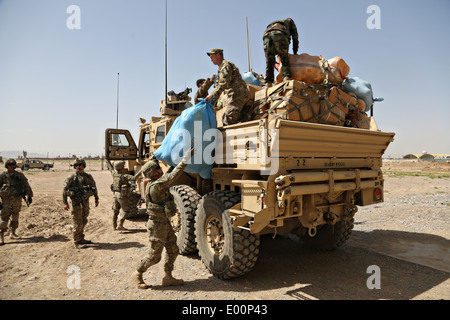 US-Soldaten zugewiesen und Afghan National Army Soldaten entladen humanitäre Hilfsgüter an einer Schule 16. April 2014 in Kandahar, Provinz Kandahar, Afghanistan. Stockfoto