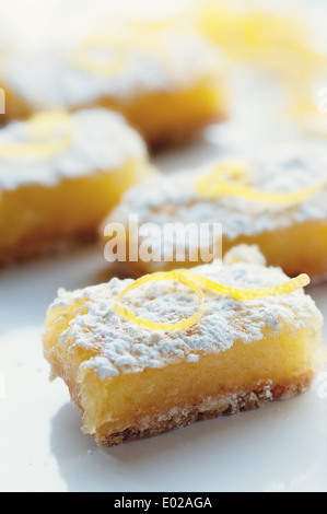 Pikanter süße Zitrone Bars mit Zitrone garnieren und Zucker des Konditors Stockfoto