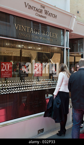 Frau auf der Suche im Vintage Watch Company Fenster in Burlington Arcade. Stockfoto