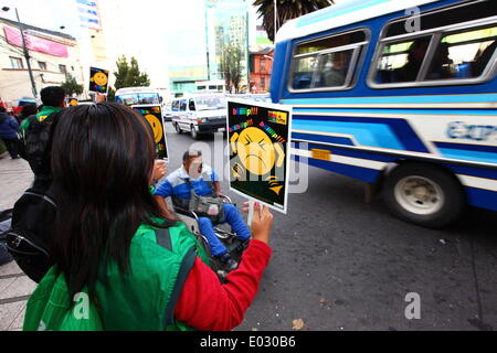 LA PAZ, Bolivien, 30. April 2014. Ein behinderter Mann schiebt seinen Rollstuhl letzten Freiwilligen halten Plakate tagsüber kein Horn / Dia De La No Bocina, Teil einer Kampagne Treiber ihr Horn weniger verwenden und zur Reduzierung der Lärmbelastung in der Stadt zu fördern. La Paz ist berüchtigt für seine chaotischen Verkehr; Das Rathaus häufig führt Kampagnen zur Verkehrssicherheit, zur Verringerung von Staus und ähnliches. Bildnachweis: James Brunker/Alamy Live-Nachrichten Stockfoto