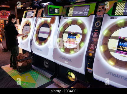 Person MaiMai Rhythmus Spiel Spielautomat zu spielen, in eine Spielhalle in Tokio, Japan Stockfoto