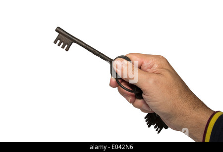 Hand mit alten Vintage Metall Schlüssel isoliert auf weiss Stockfoto