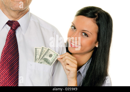 Junge Frau mit einem Mann zieht Geld aus der Tasche. Dollar, Zieht Junge Frau Einem Mann Geld aus der Tasche.Dollar Stockfoto