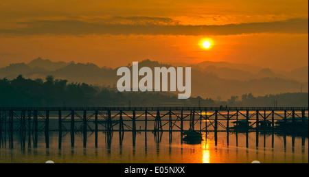 Der Sonnenaufgang am Morgen hinter der Holzbrücke. Stockfoto