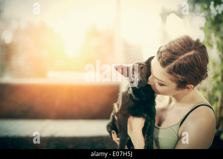 Junge Frau mit Hund zu Hause spielen Stockfoto