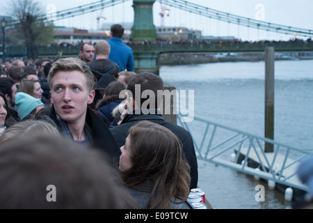 Zuschauer am Ufer der Themse in Hammersmith während der jährlichen Oxford and Cambridge Boat Race. Stockfoto