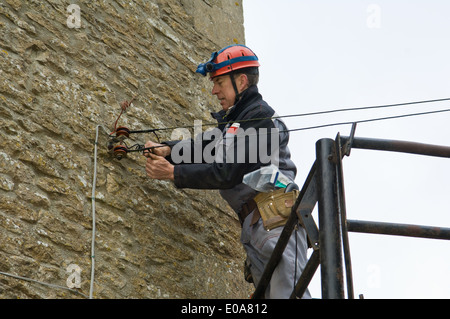 Männliche Elektriker auf Plattform Befestigung Haus Strom liefern Stockfoto